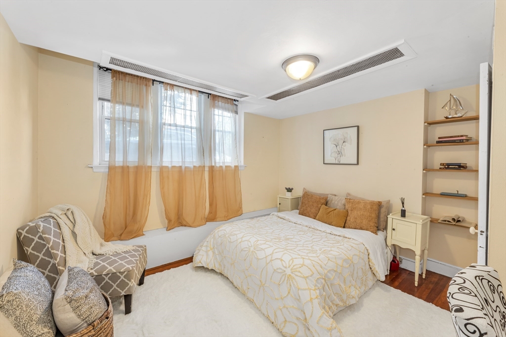 48 Robinwood Avenue, Unit W2 Boston, MA 02130 - Photo 7 of 12 a bedroom with a bed and a couch