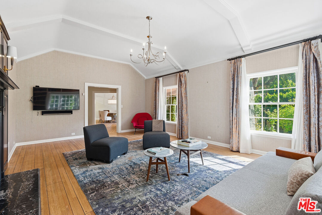 9305 Hazen Drive Beverly Hills, CA 90210 - Photo 14 of 59 a living room with furniture a window and a chandelier