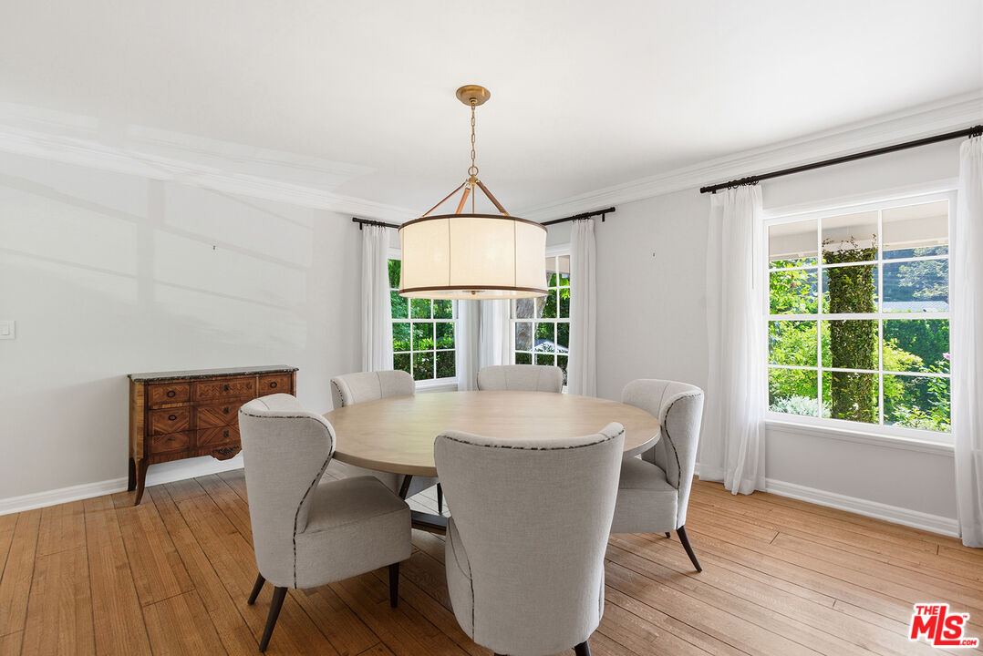 9305 Hazen Drive Beverly Hills, CA 90210 - Photo 17 of 59 a dining room with furniture window wooden floor