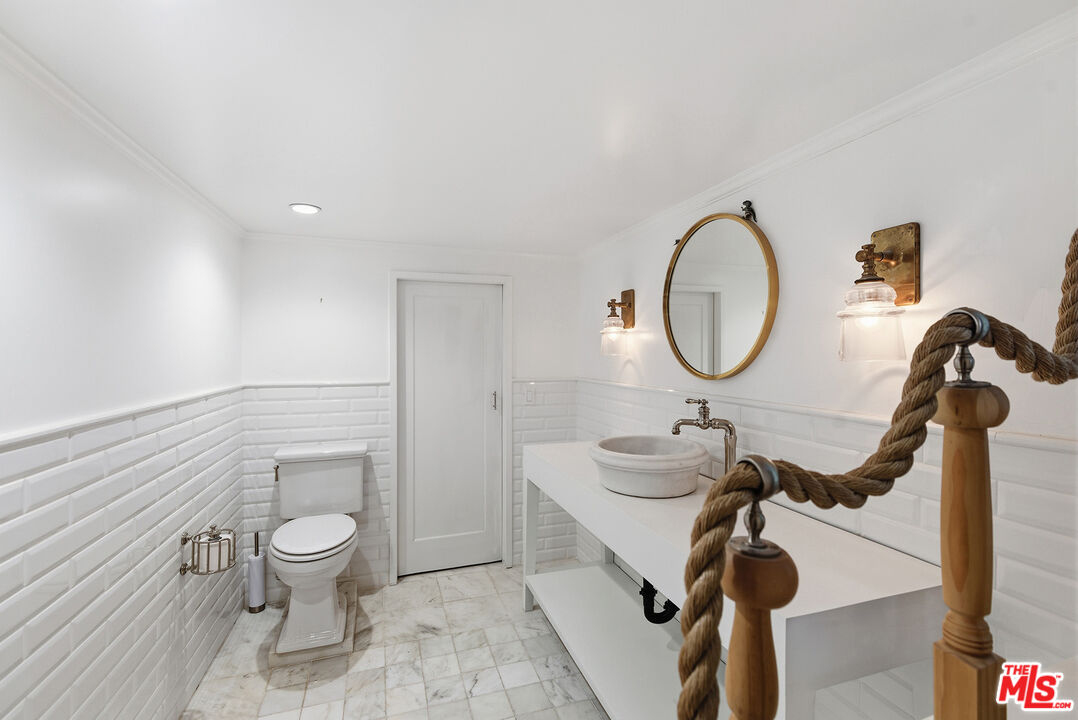 9305 Hazen Drive Beverly Hills, CA 90210 - Photo 20 of 59 a bathroom with a sink mirror and toilet