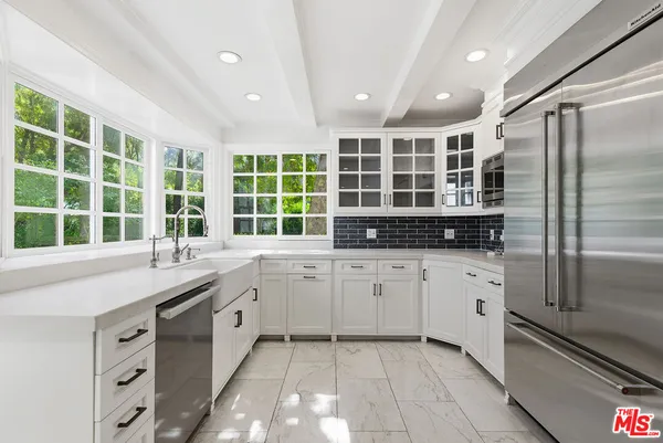 a kitchen with granite countertop a stove oven and sink