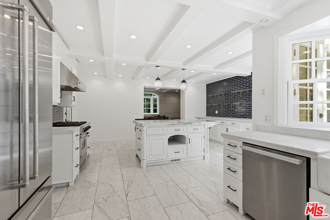 9305 Hazen Drive Beverly Hills, CA 90210 - Photo 22 of 59 a spacious bathroom with a double vanity sink a mirror and a shower
