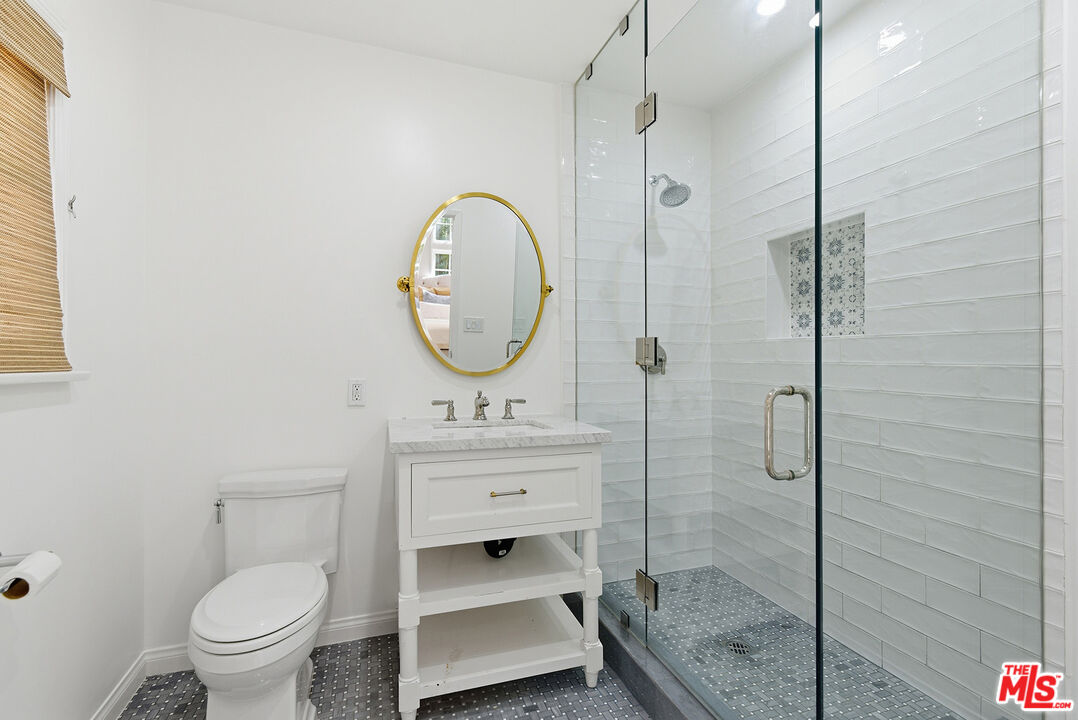 9305 Hazen Drive Beverly Hills, CA 90210 - Photo 34 of 59 a bathroom with a toilet a sink and a shower