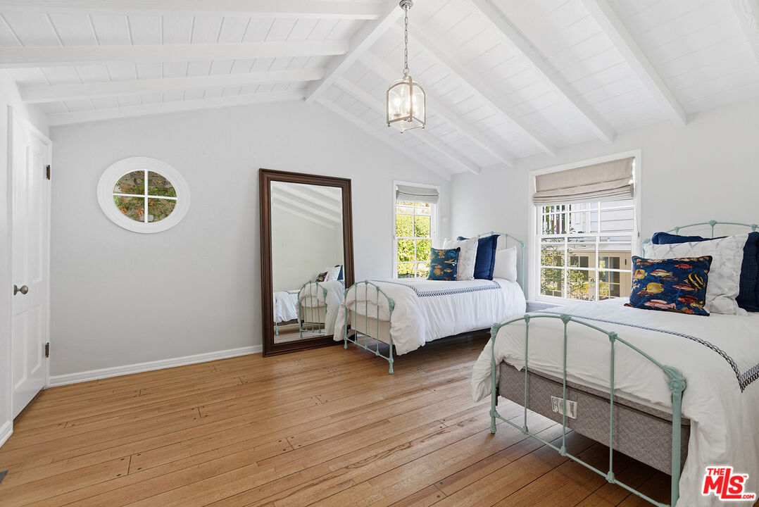 9305 Hazen Drive Beverly Hills, CA 90210 - Photo 35 of 59 a bedroom with furniture and a window