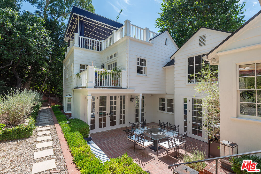 9305 Hazen Drive Beverly Hills, CA 90210 - Photo 52 of 59 a view of a patio with table and chairs and potted plants
