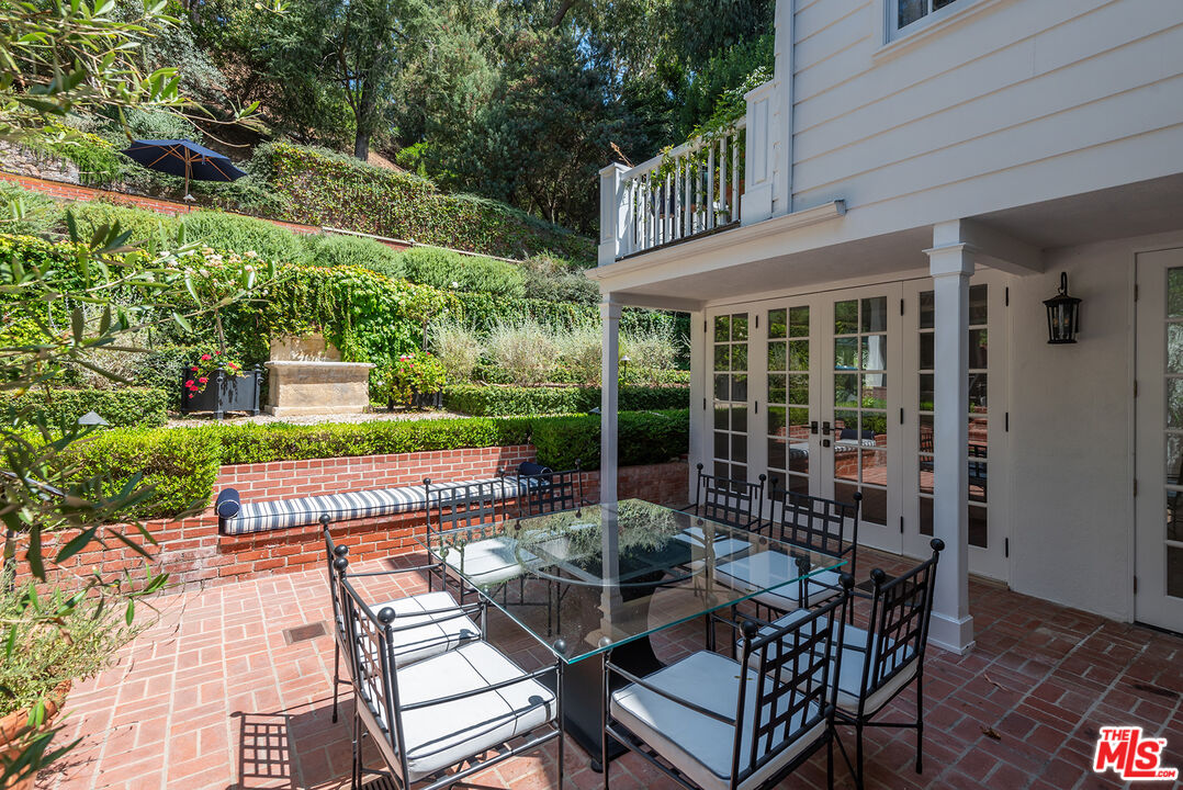 9305 Hazen Drive Beverly Hills, CA 90210 - Photo 53 of 59 a view of a patio with a table chairs and a patio
