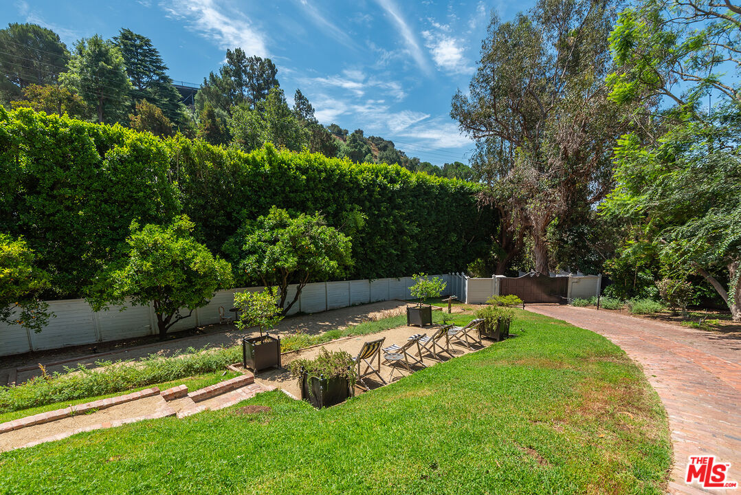 9305 Hazen Drive Beverly Hills, CA 90210 - Photo 8 of 59 a view of a backyard with couches plants and large trees