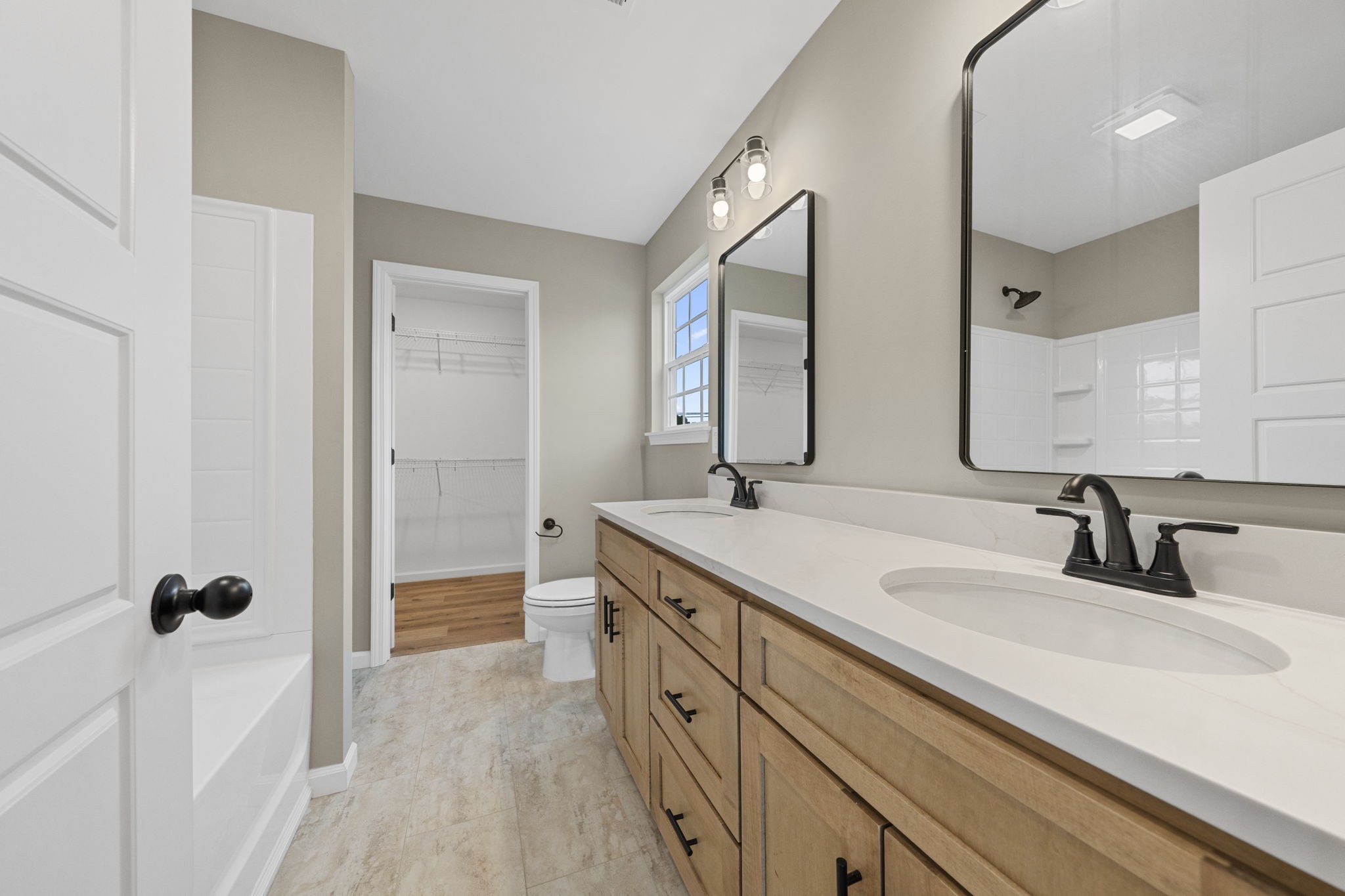 1105 Brook Court Franklin, KY 42134 - Photo 14 of 27 a spacious bathroom with a double vanity sink a mirror and a bathtub