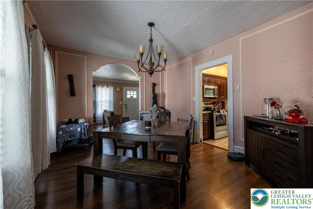 118 South 3rd Street Bangor, PA 18013 - Photo 9 of 33 This inviting dining area features dark wood flooring, an arched entryway, and a striking chandelier.