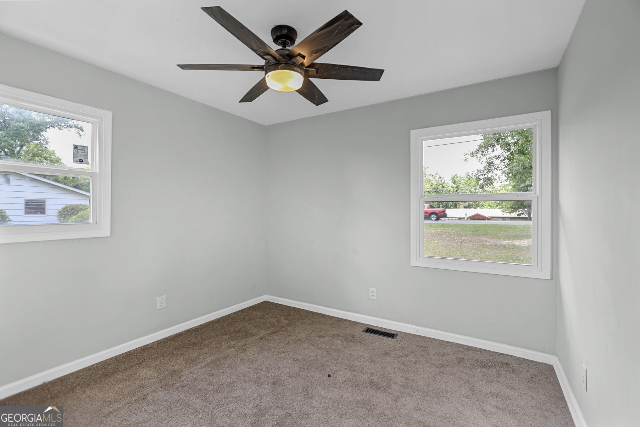 7060 Scenic Heights Road Manchester, GA 31816 - Photo 23 of 52 an empty room with a window and a fan