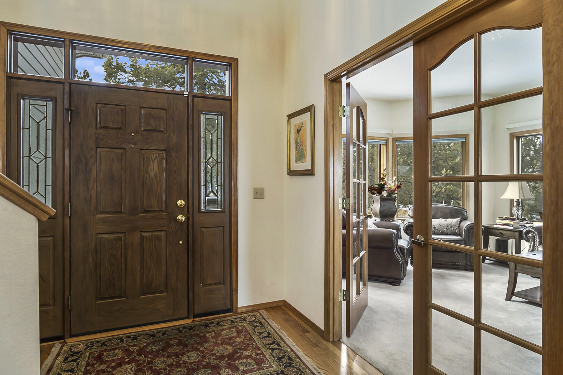 3808 Northwest Summerfield Road Bend, OR 97703 - Photo 3 of 38 Walk in the grand entry way with vaulted ceiling and double glass doors leading into the cozy living room.