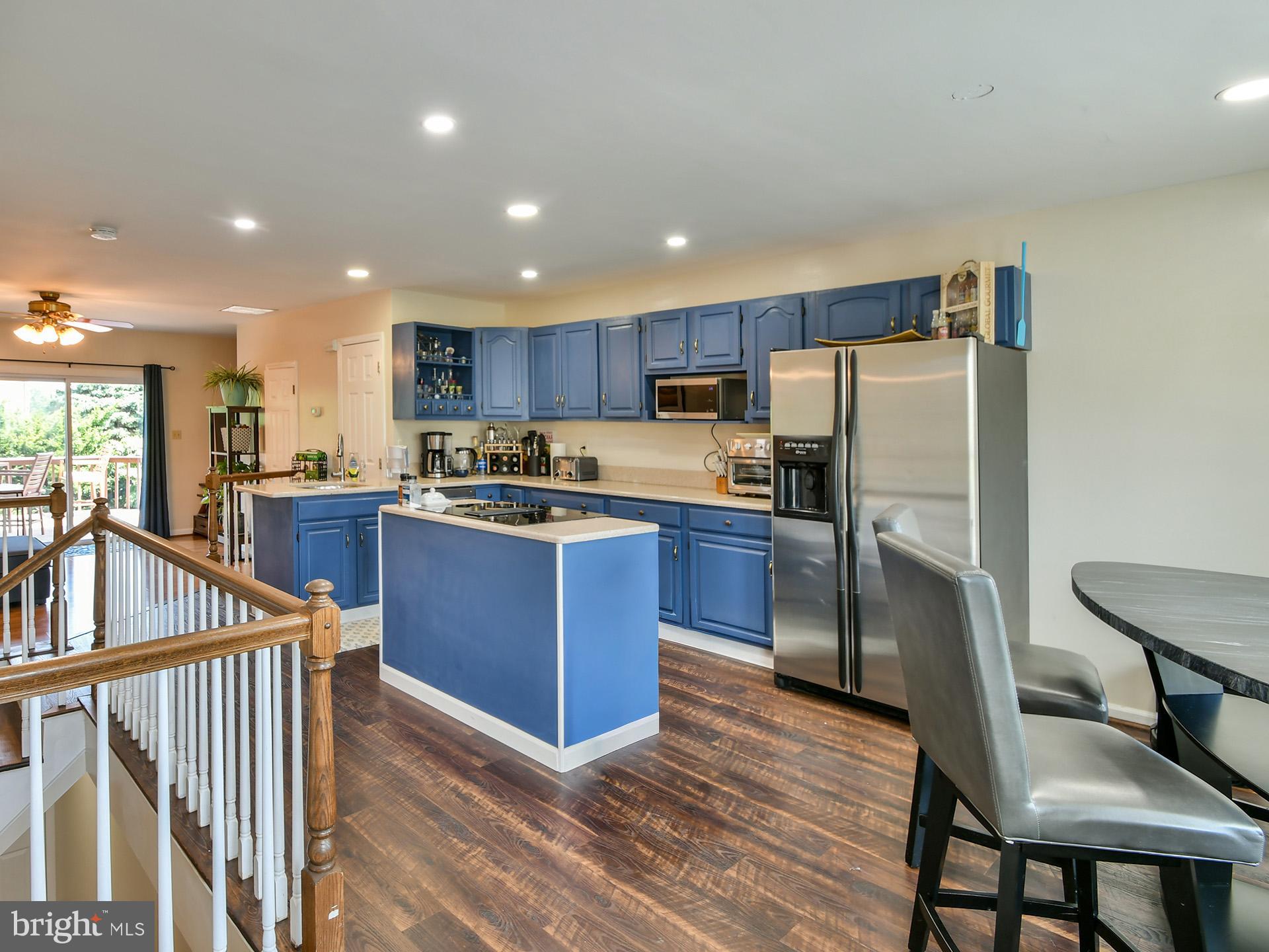 42 Victoria Square Frederick, MD 21702 - Photo 3 of 43 a kitchen with stainless steel appliances wooden floor and a refrigerator