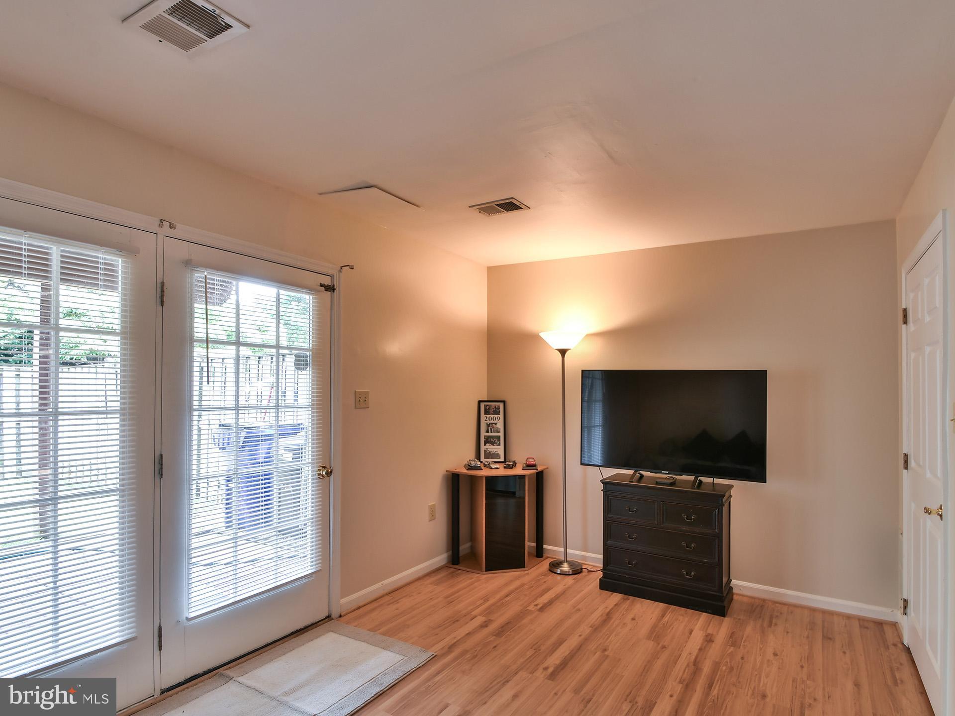 42 Victoria Square Frederick, MD 21702 - Photo 35 of 43 a living room with a flat screen tv and a chandelier