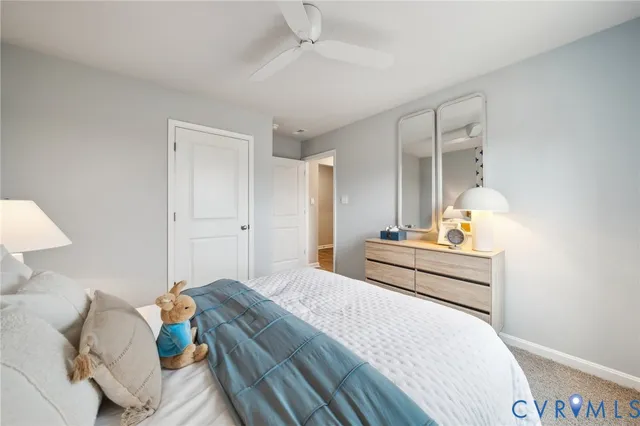 a bedroom with a bed and a lamp on table