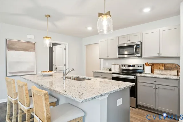a kitchen with granite countertop kitchen island cabinets and a sink