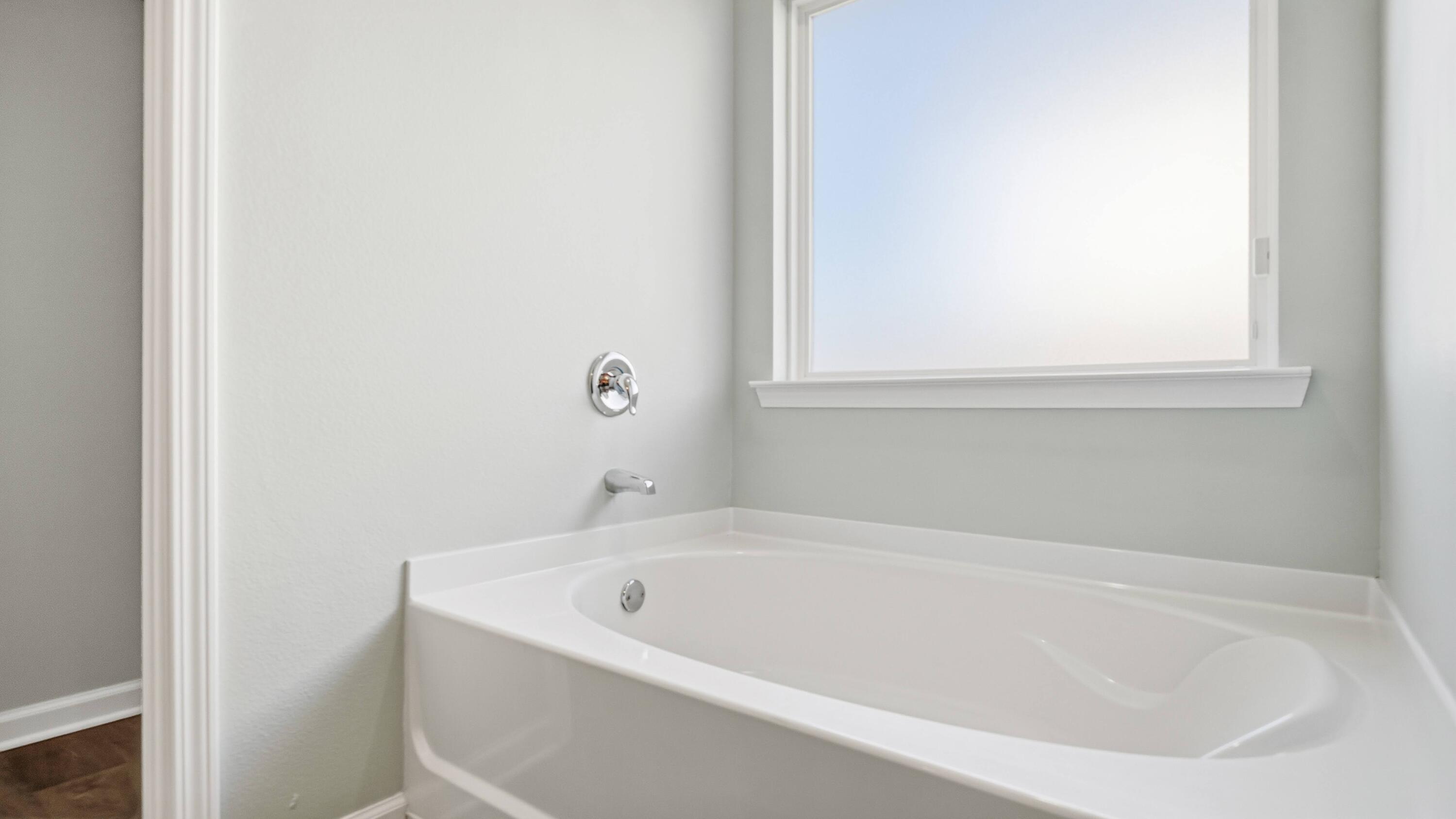 3927 Alva Thomas Road Panama City, FL 32404 - Photo 15 of 46 a white bath tub sitting next to a window