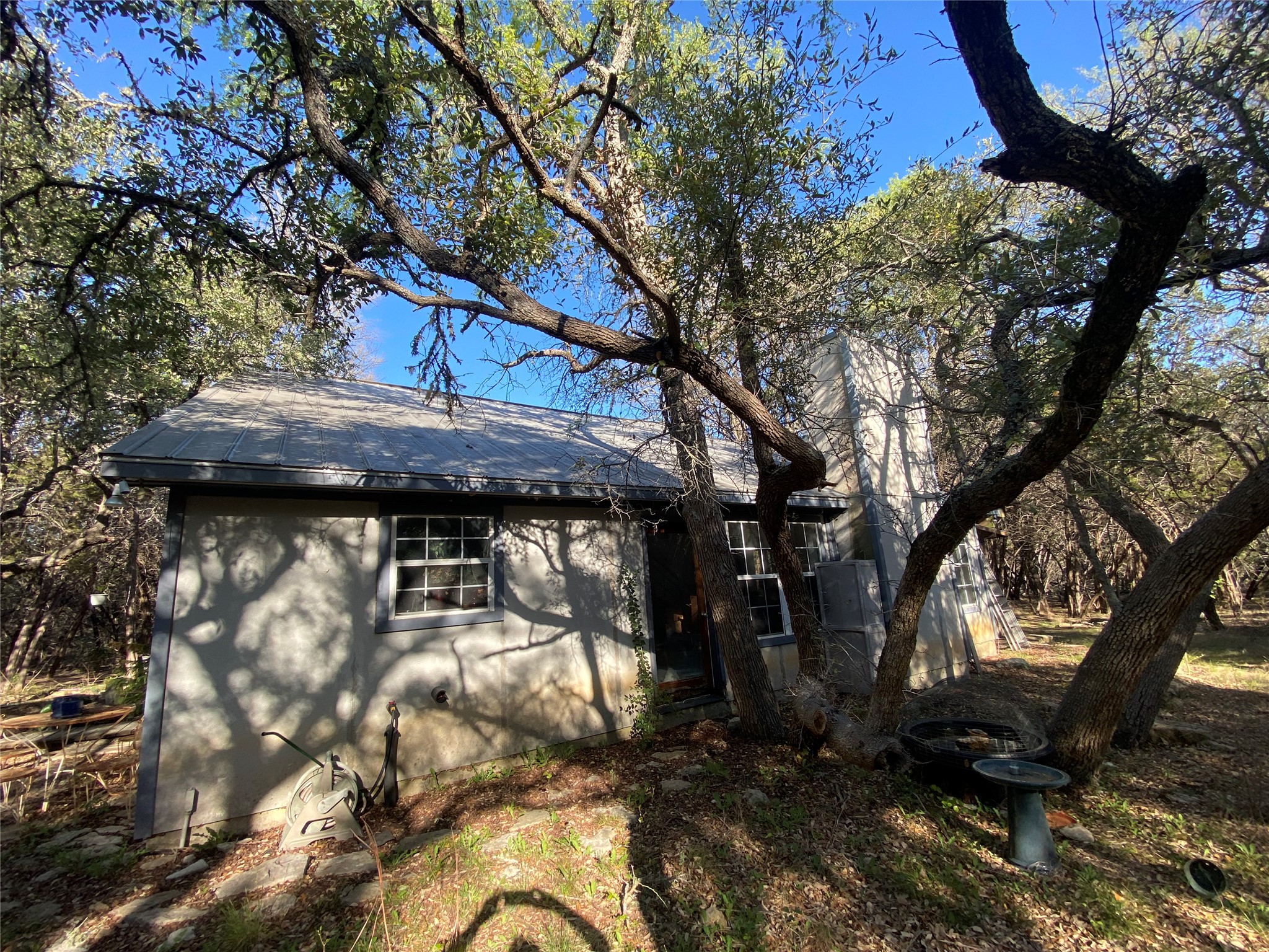 1850 North Rainbow Ranch Road Wimberley, TX 78676 - Photo 23 of 26 a view of backyard with wooden fence and large trees