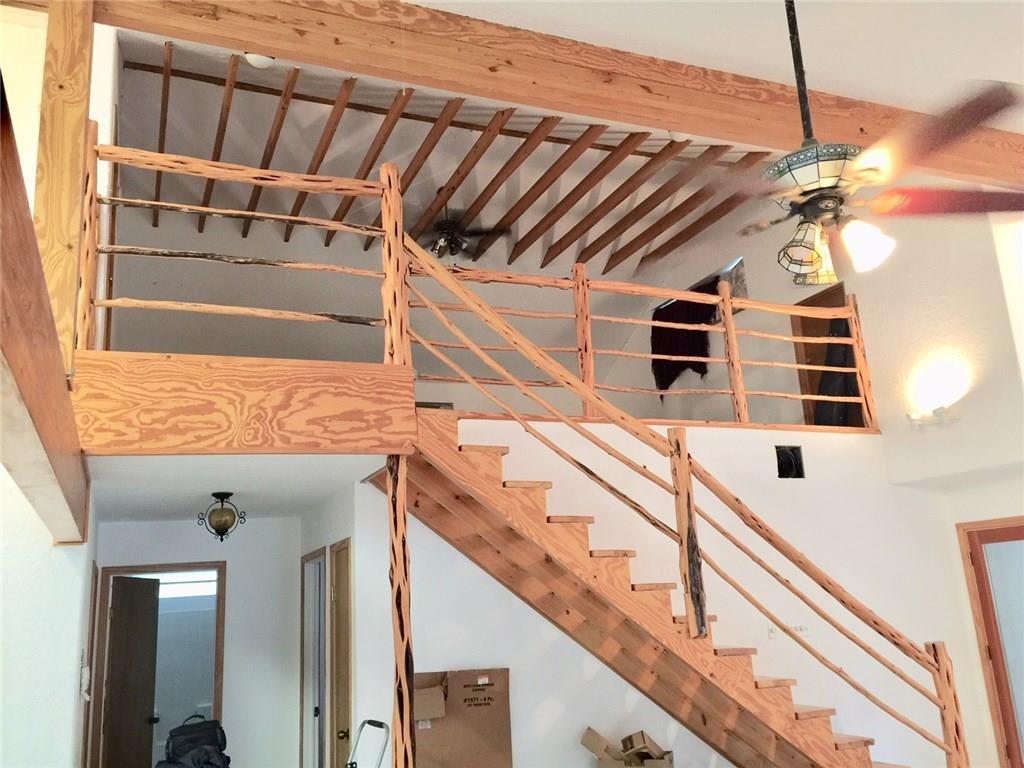 1850 North Rainbow Ranch Road Wimberley, TX 78676 - Photo 4 of 26 a view of a balcony with a white door and wooden floor