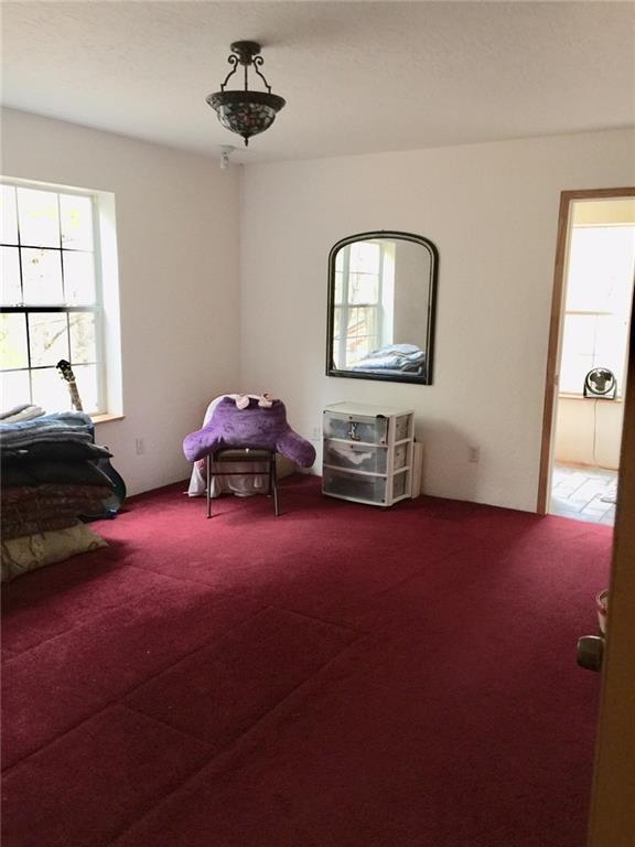 1850 North Rainbow Ranch Road Wimberley, TX 78676 - Photo 6 of 26 a bedroom with bed and window