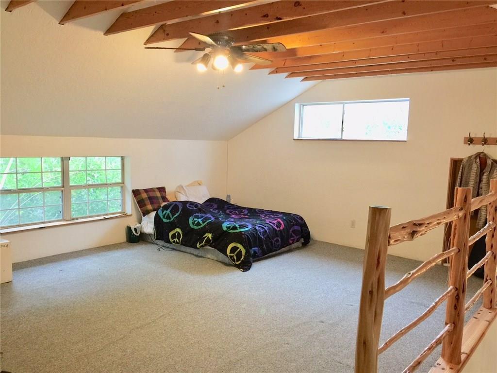 1850 North Rainbow Ranch Road Wimberley, TX 78676 - Photo 8 of 26 a bedroom with a bed and a window