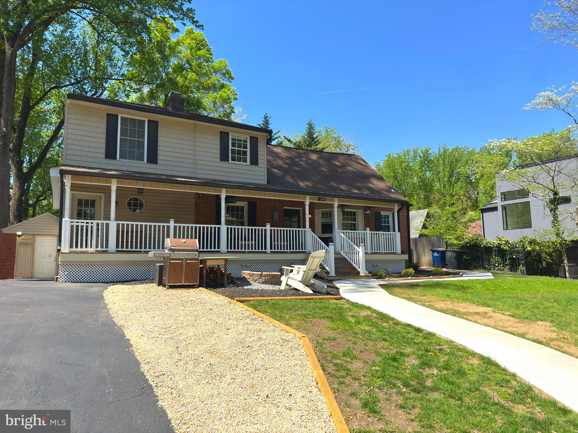 a house view with a sitting space and garden