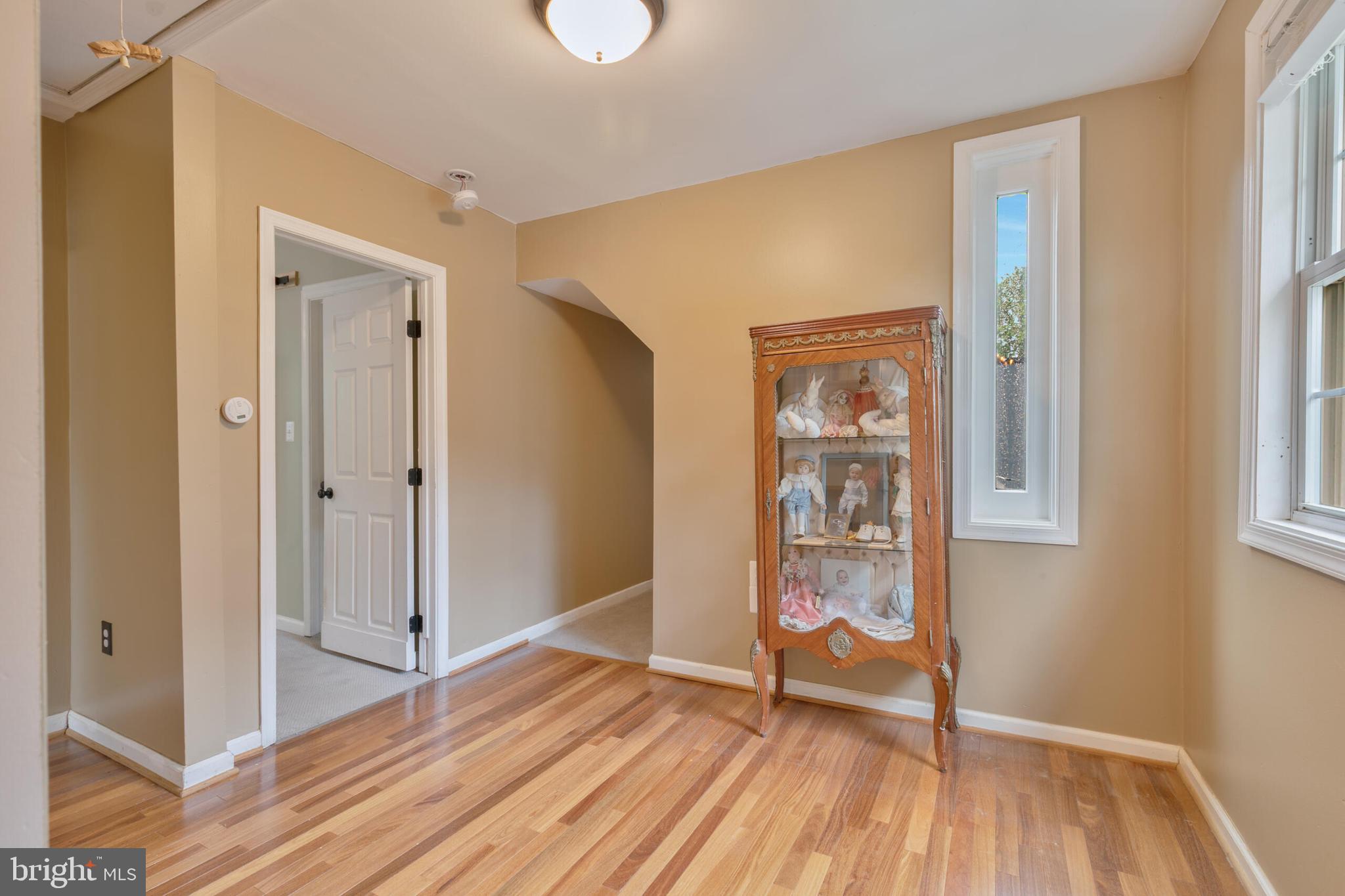 210 Northmoor Drive Silver Spring, MD 20901 - Photo 16 of 43 a view of an empty room with wooden floor and a window