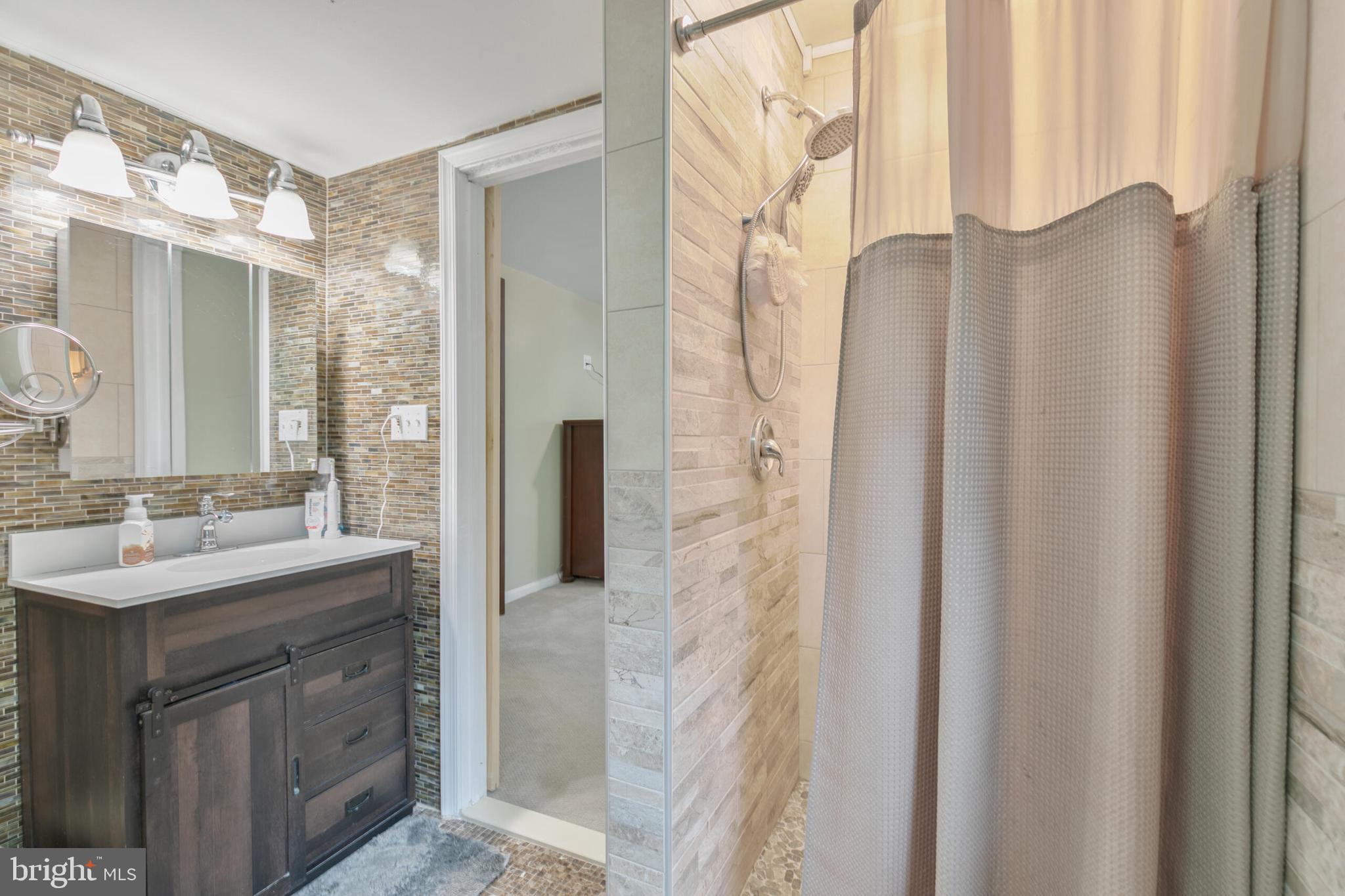 210 Northmoor Drive Silver Spring, MD 20901 - Photo 21 of 43 a bathroom with a sink and a mirror