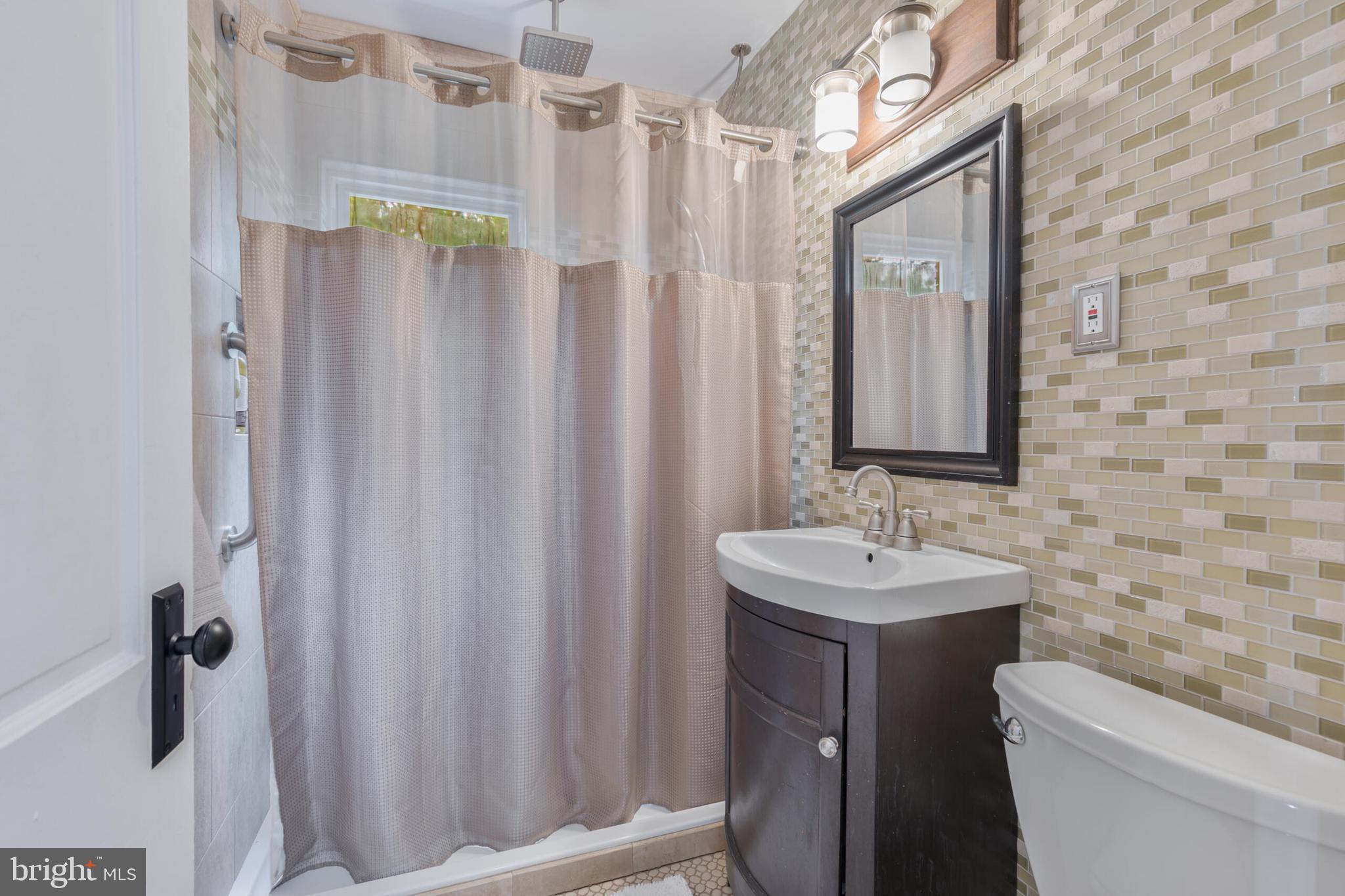 210 Northmoor Drive Silver Spring, MD 20901 - Photo 27 of 43 a bathroom with a sink a toilet and shower
