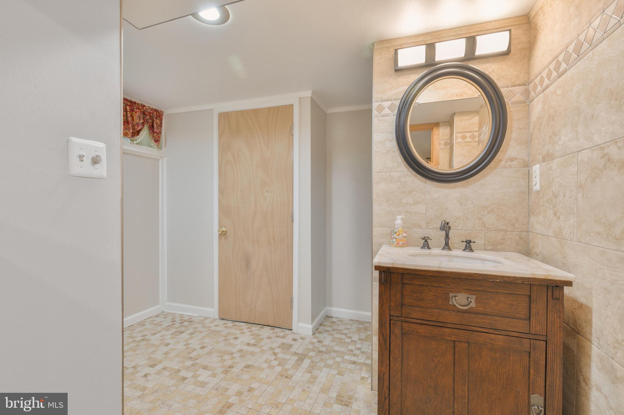210 Northmoor Drive Silver Spring, MD 20901 - Photo 30 of 43 a bathroom with a granite countertop sink and a mirror