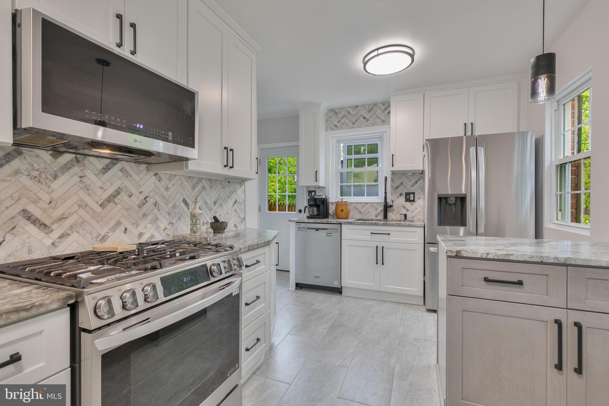 210 Northmoor Drive Silver Spring, MD 20901 - Photo 8 of 43 a kitchen with white cabinets and appliances