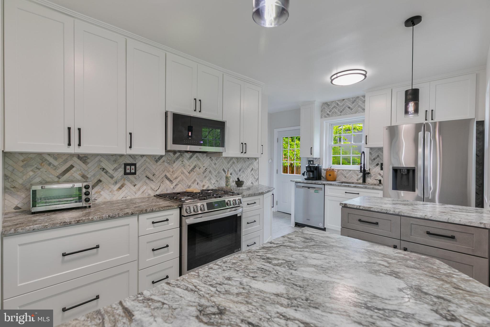 210 Northmoor Drive Silver Spring, MD 20901 - Photo 9 of 43 a kitchen with stainless steel appliances granite countertop a stove a sink and a refrigerator