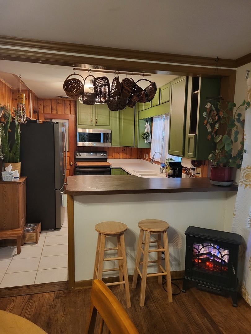 914 Cooper Street Dixon, IL 61021 - Photo 5 of 10 a kitchen with stainless steel appliances granite countertop a sink and a refrigerator