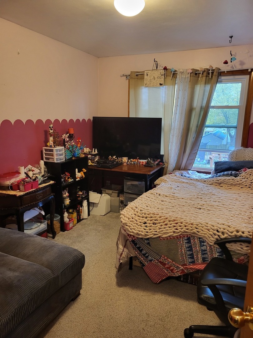 914 Cooper Street Dixon, IL 61021 - Photo 7 of 10 a bedroom with furniture and a flat screen tv