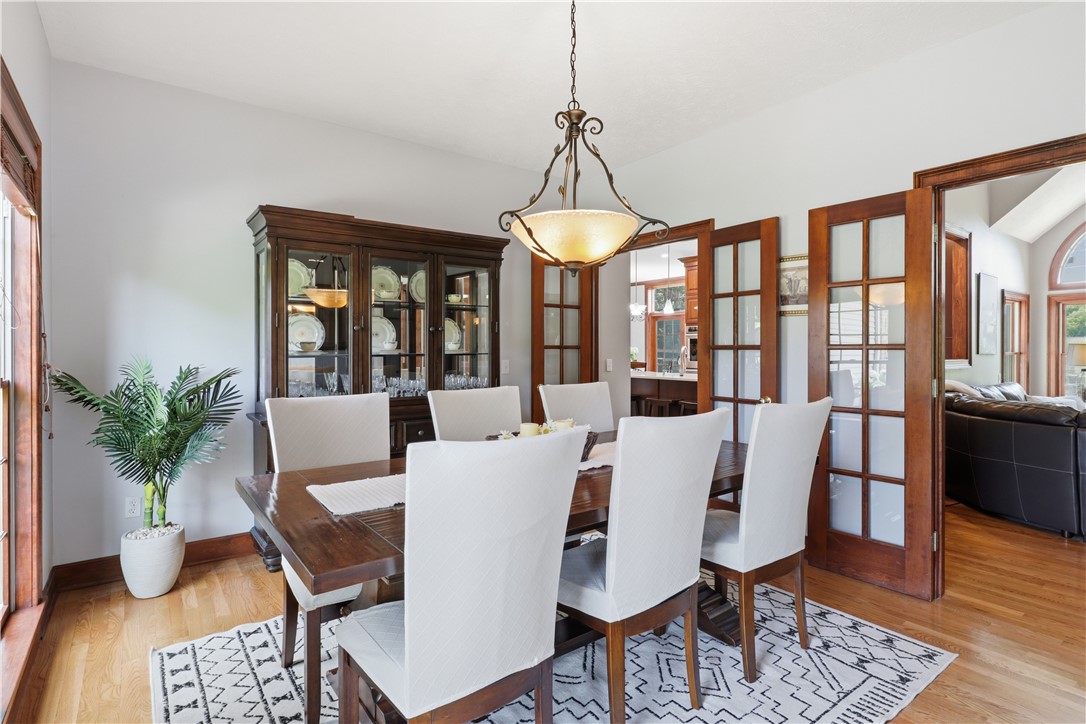 2057 Stirnie Road Victor, NY 14564 - Photo 16 of 48 A wide-angle perspective highlighting the seamless transition between the central living areas and the separate formal dining room, perfectly suited for hosting elegant dinner parties.