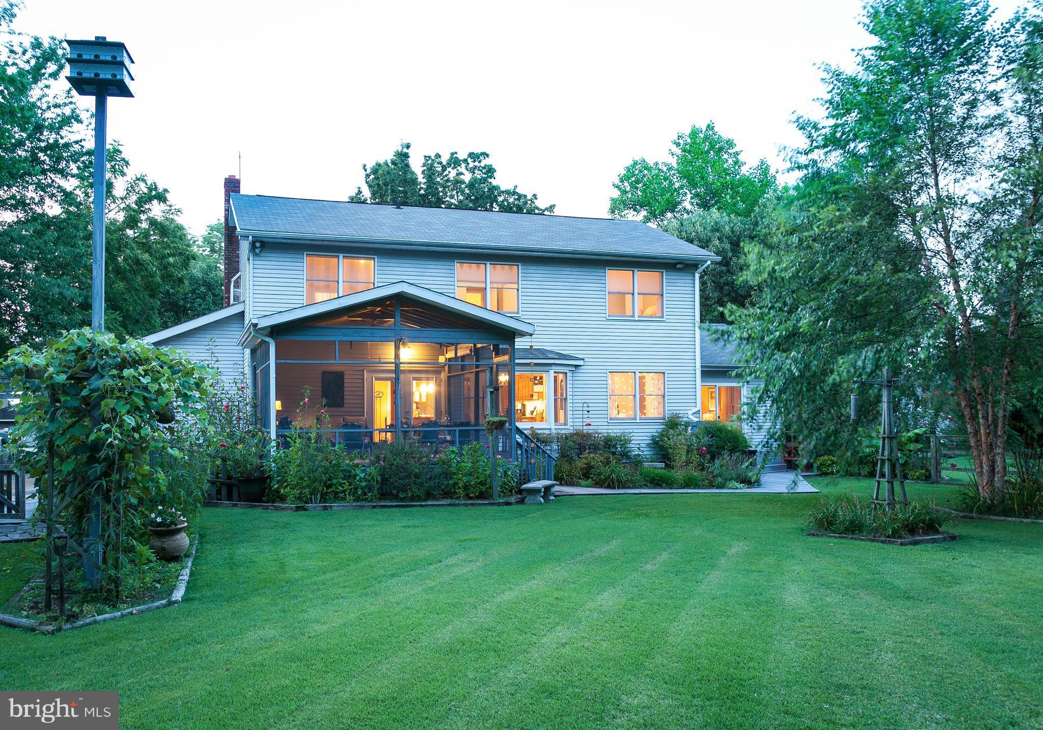 1135 River Bay Road Annapolis, MD 21409 - Photo 26 of 28 Twilight view of porch and flat back yard