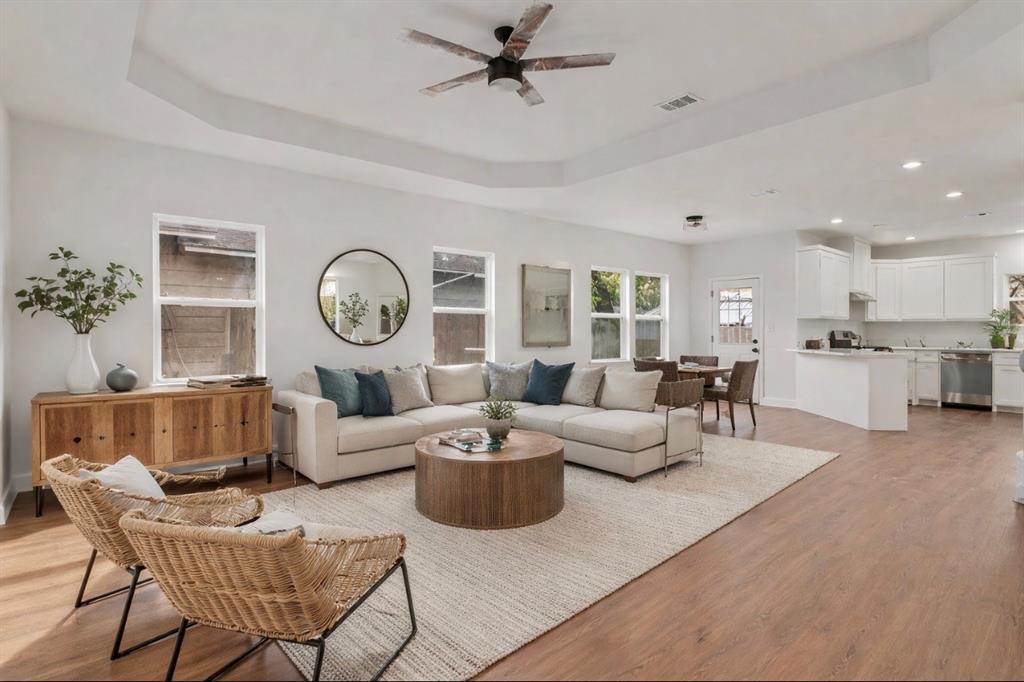 a living room with furniture a clock on wall and a clock