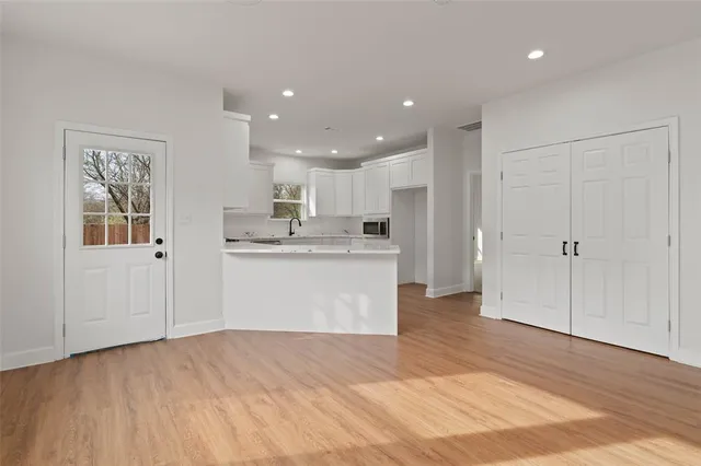 a view of kitchen with wooden floor and electronic appliances