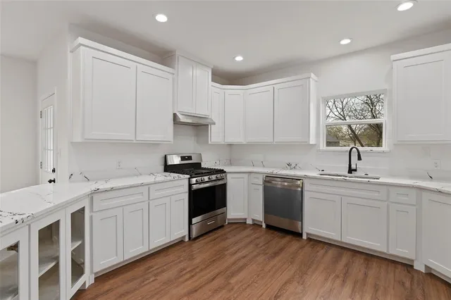 a kitchen with a sink stove and cabinets