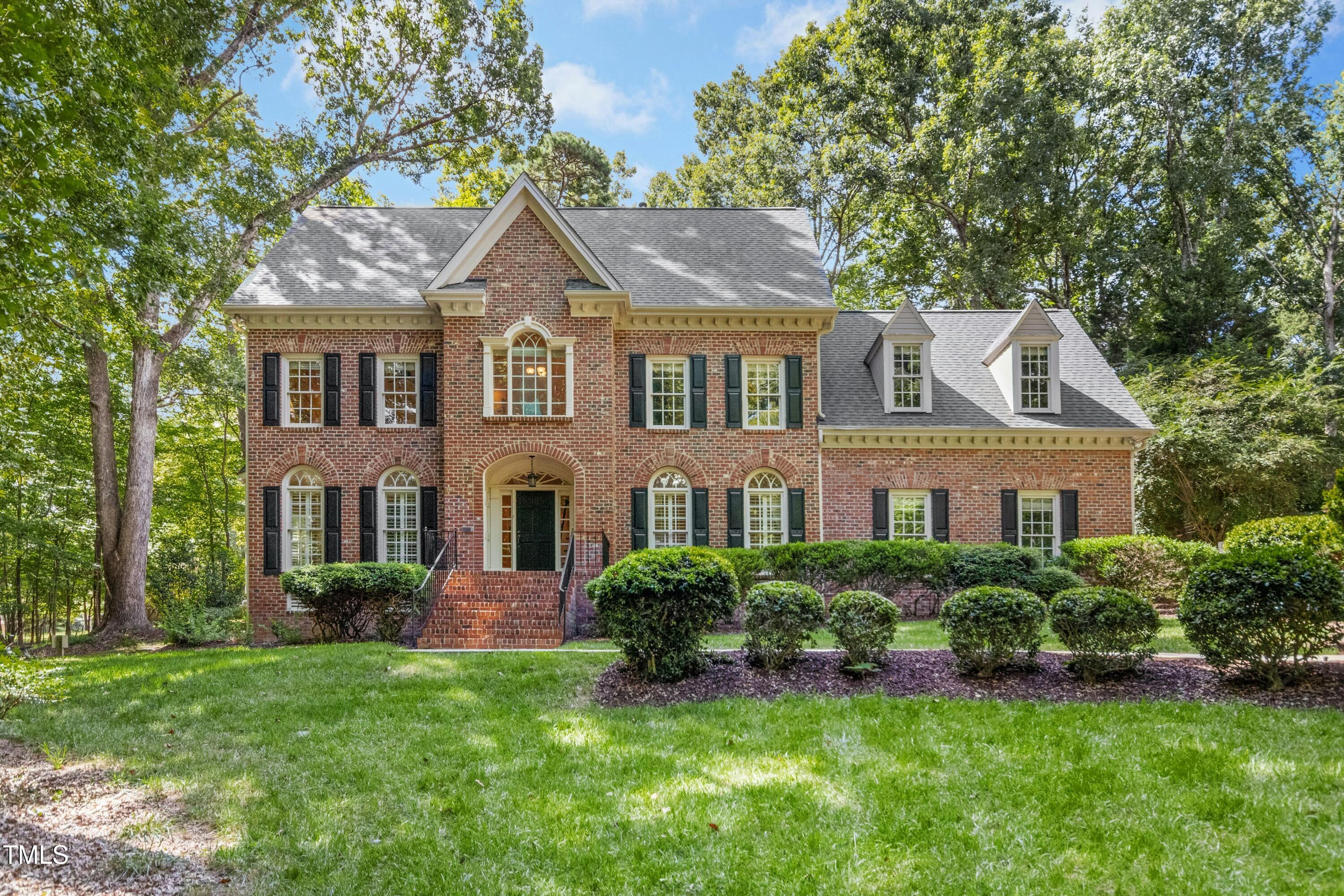 12317 Lockhart Lane Raleigh, NC 27614 - Photo 1 of 38 a front view of a house with a yard