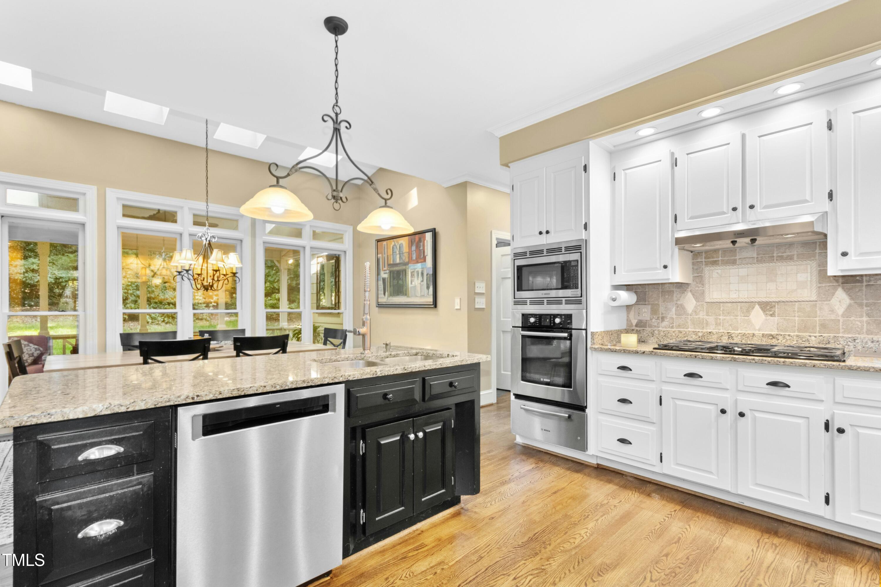 12317 Lockhart Lane Raleigh, NC 27614 - Photo 12 of 38 a kitchen with stainless steel appliances kitchen island granite countertop a sink and cabinets