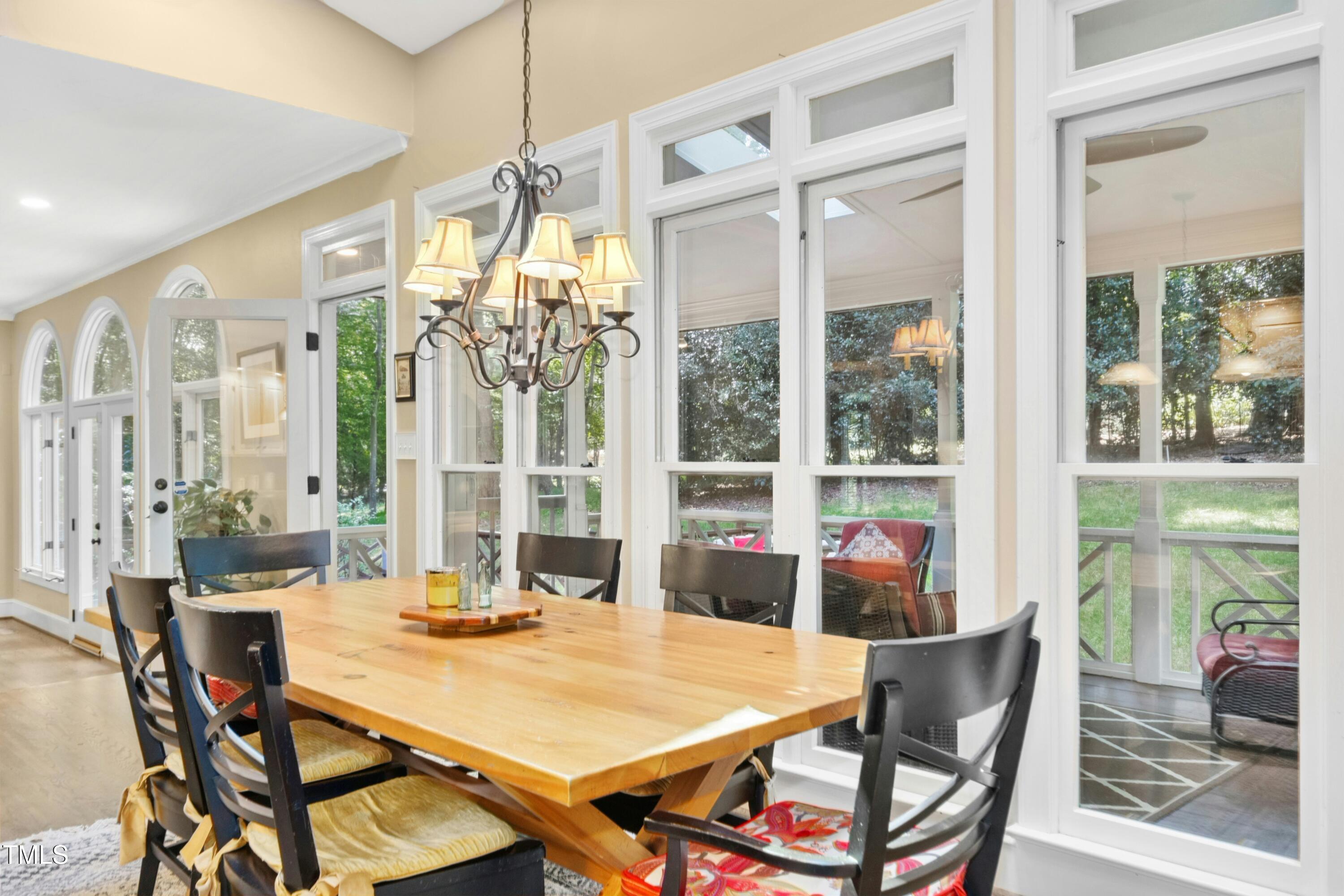 12317 Lockhart Lane Raleigh, NC 27614 - Photo 14 of 38 a view of a dining room with furniture large windows and wooden floor