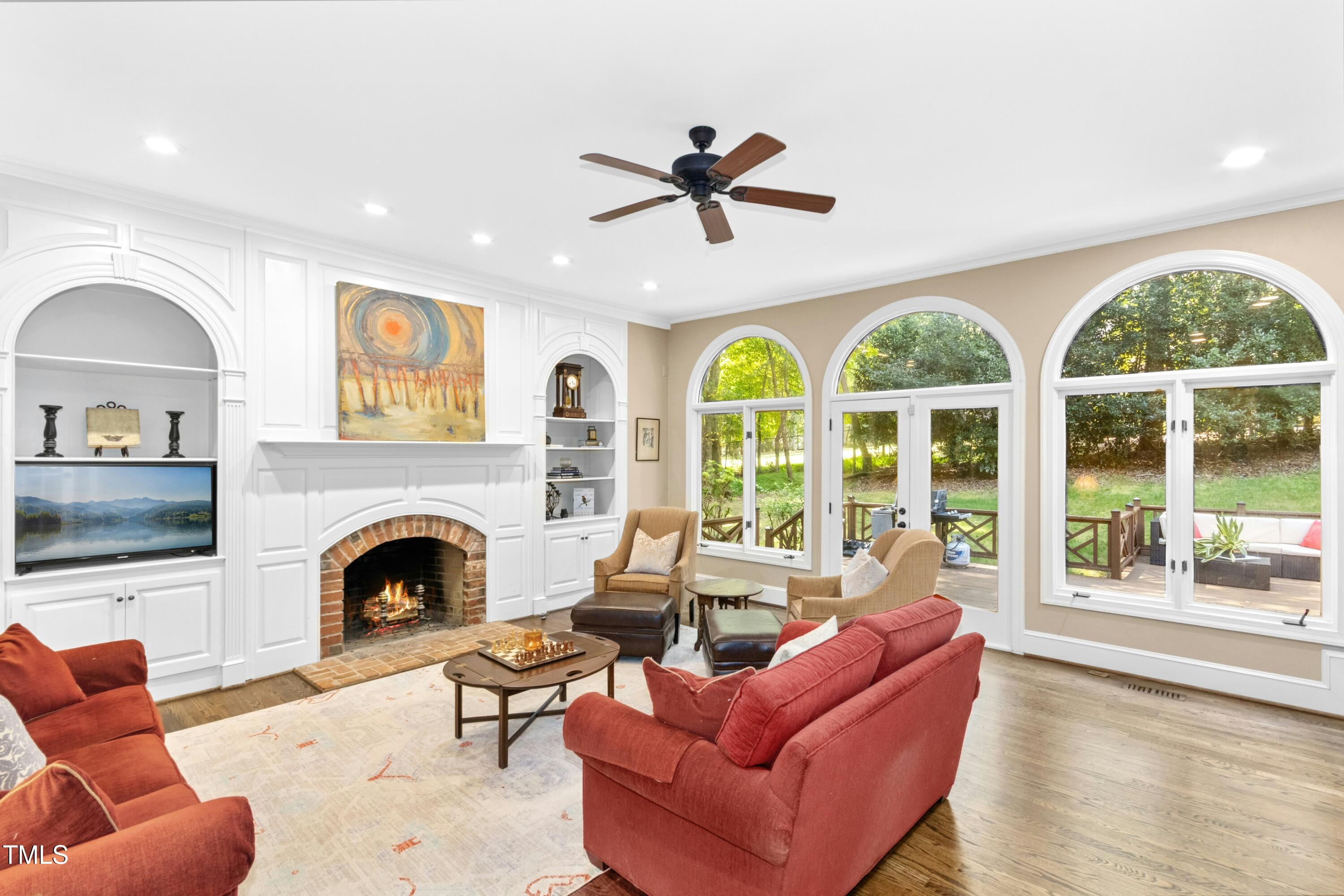 12317 Lockhart Lane Raleigh, NC 27614 - Photo 16 of 38 a living room with furniture fireplace and a large window