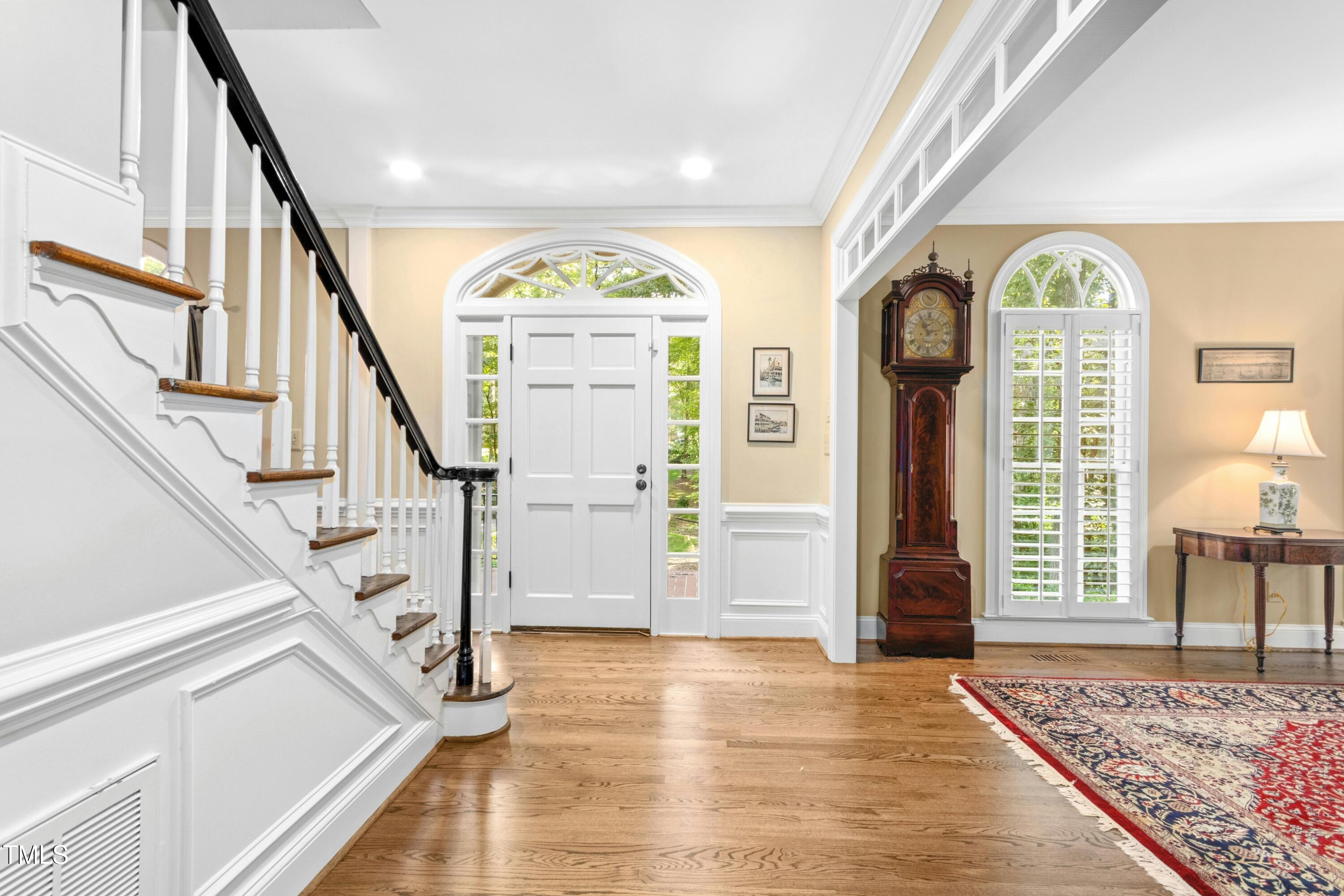 12317 Lockhart Lane Raleigh, NC 27614 - Photo 2 of 38 a view of an entryway with wooden floor windows and a livingroom