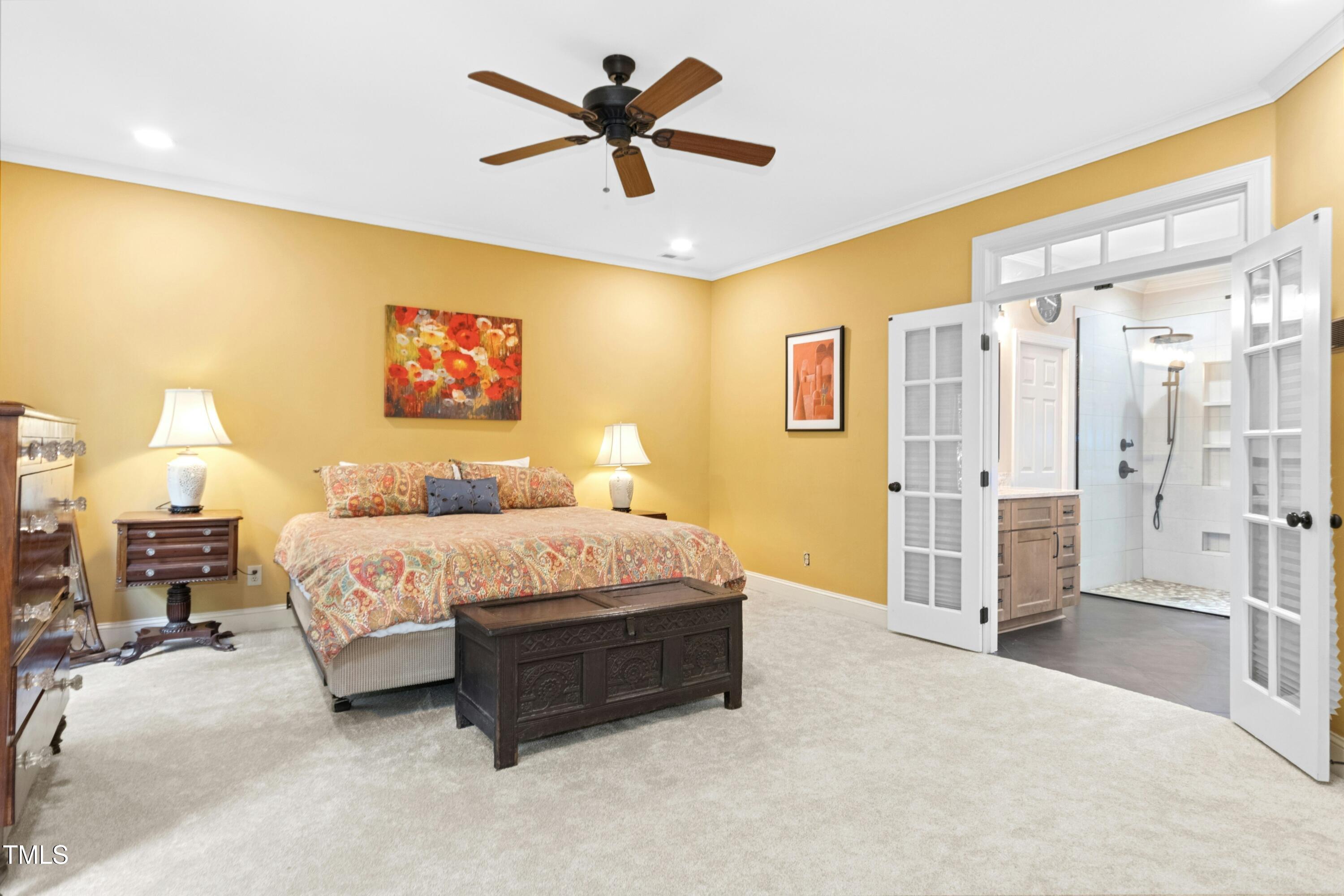 12317 Lockhart Lane Raleigh, NC 27614 - Photo 25 of 38 a spacious bedroom with a bed and a chandelier