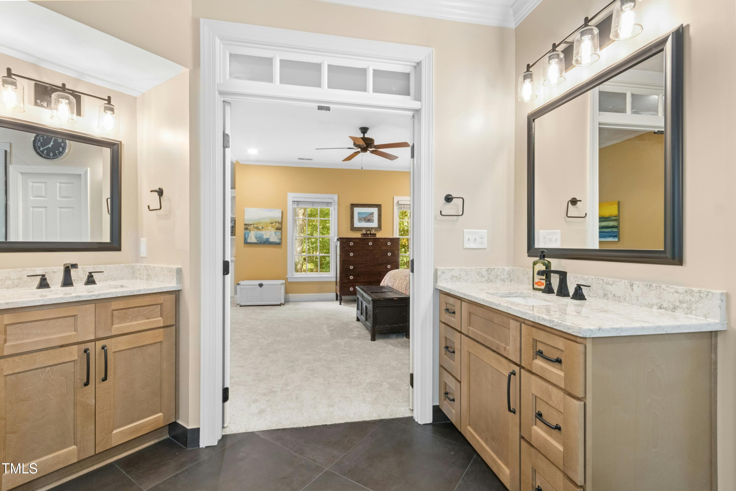 12317 Lockhart Lane Raleigh, NC 27614 - Photo 27 of 38 a bathroom with a double vanity sink and mirror with shower