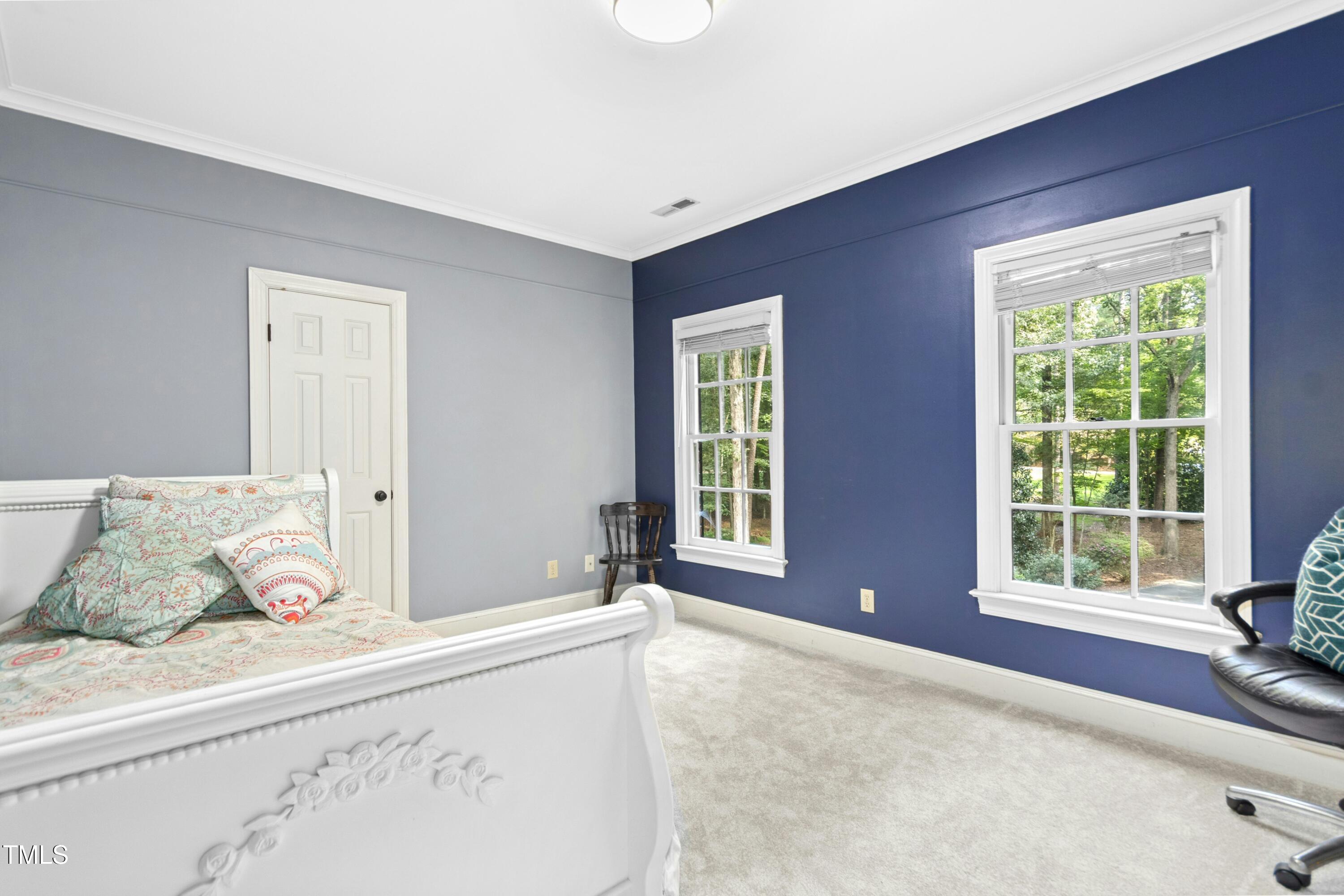12317 Lockhart Lane Raleigh, NC 27614 - Photo 29 of 38 a bedroom with a bed and windows