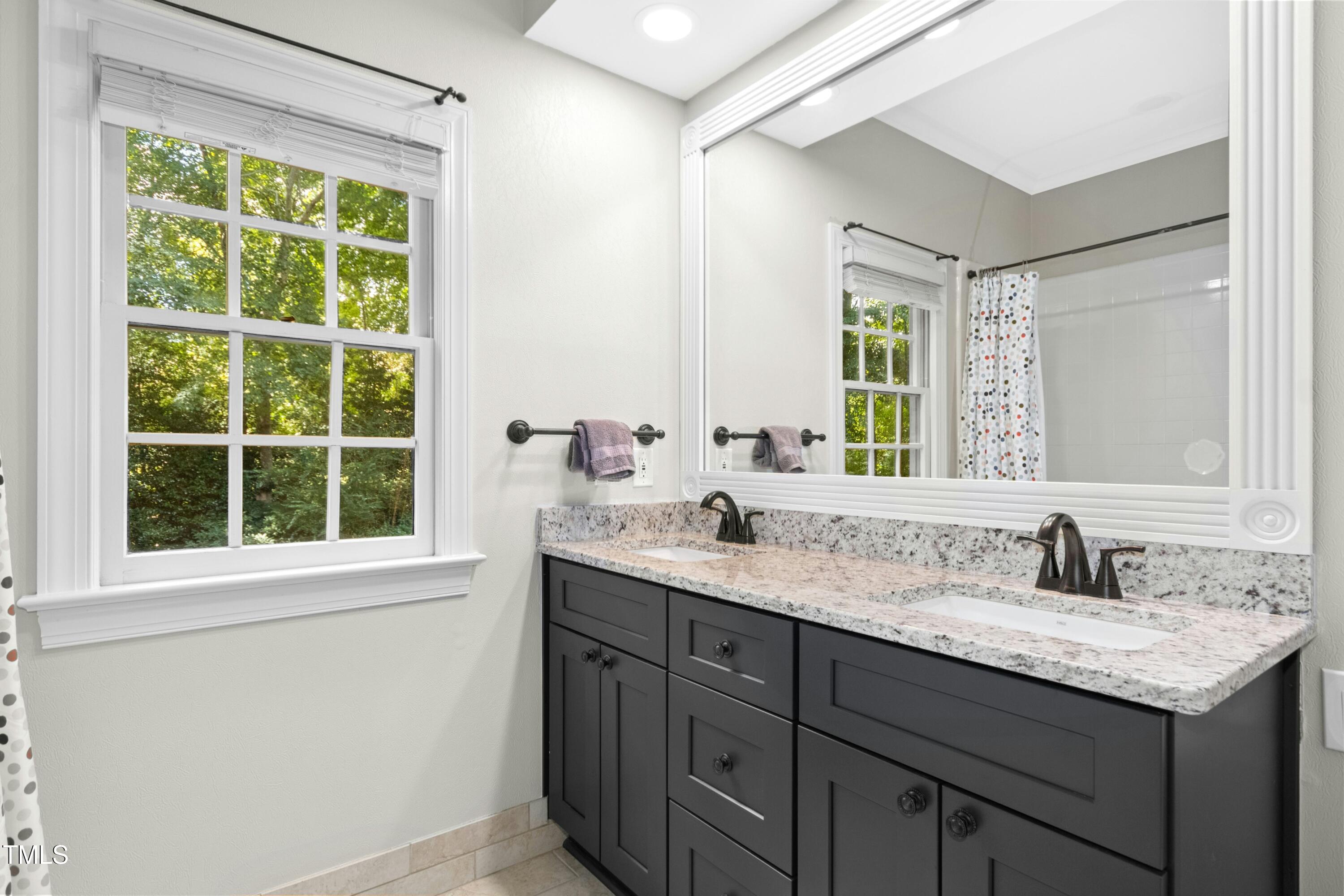 12317 Lockhart Lane Raleigh, NC 27614 - Photo 30 of 38 a bathroom with a sink and a window