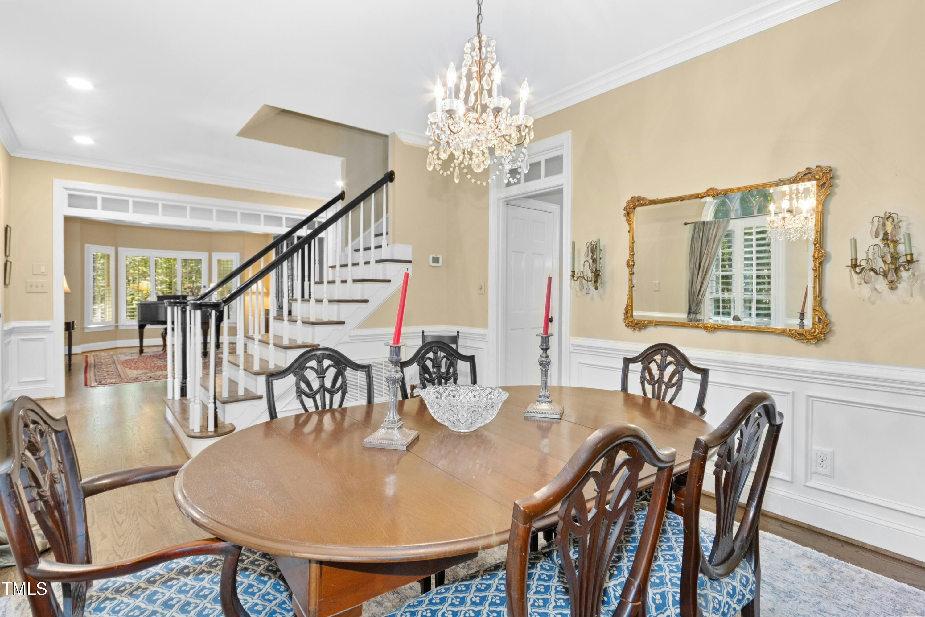 12317 Lockhart Lane Raleigh, NC 27614 - Photo 8 of 38 a dining room with furniture a chandelier and wooden floor