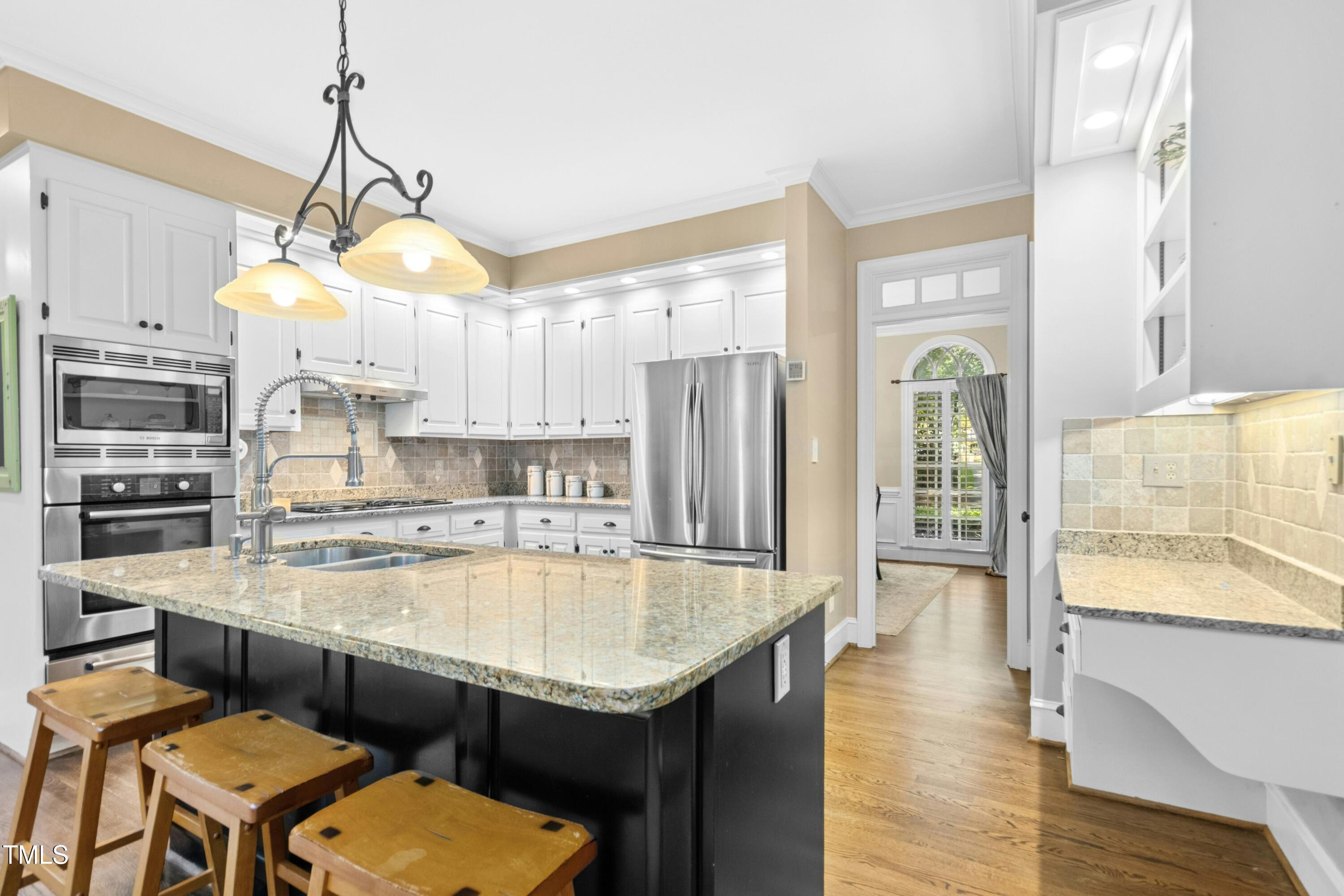 12317 Lockhart Lane Raleigh, NC 27614 - Photo 10 of 38 a kitchen with a refrigerator a sink and a stove