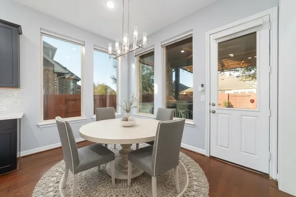 a view of a dining room with furniture wooden floor and chandelier